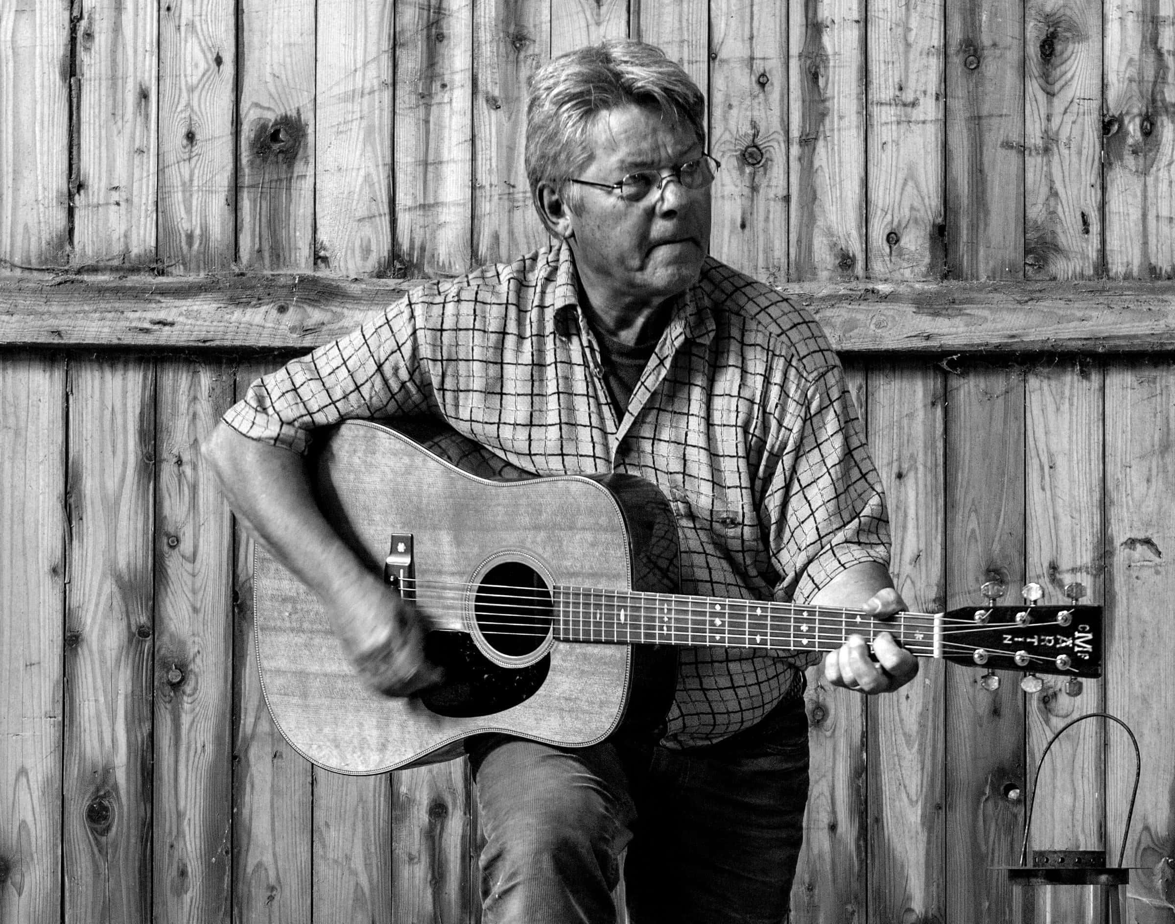 Erik Grip står med sin guitar